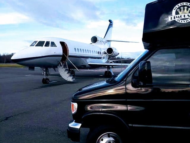 Northwest Limousine bus parked in front of a private jet